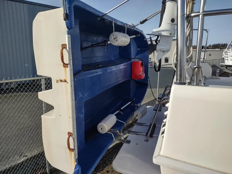 Slide: The Image of 2002 Endeavour Trawlercat 36 with blue dinghy and marine equipment on deck. - 12