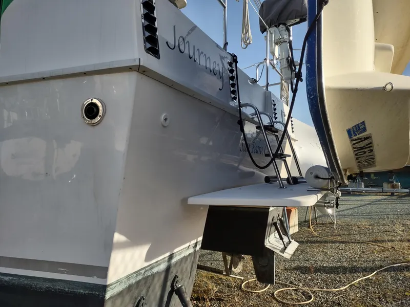 Slide: The Image of 2002 Endeavour Trawlercat 36 docked, showing stern details and equipment. - 13