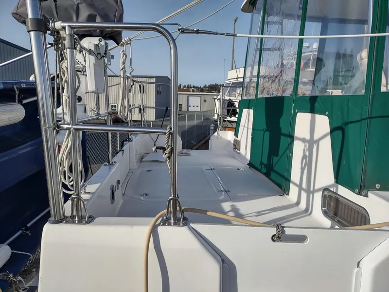 Slide: The Image of 2002 Endeavour Trawlercat 36 deck with green canopy and metal railings. - 15