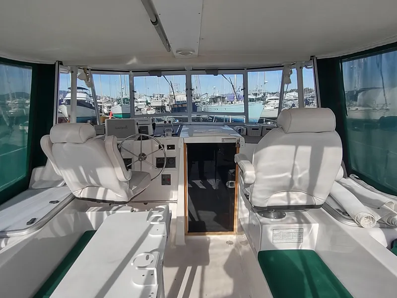 Slide: The Image of Interior view of 2002 Endeavour Trawlercat 36 with helm and seating area. - 30