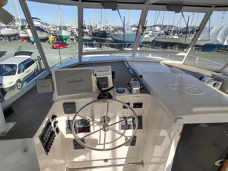 Slide: The Image of Helm of 2002 Endeavour Trawlercat 36 with Garmin navigation system, docked in marina. - 37
