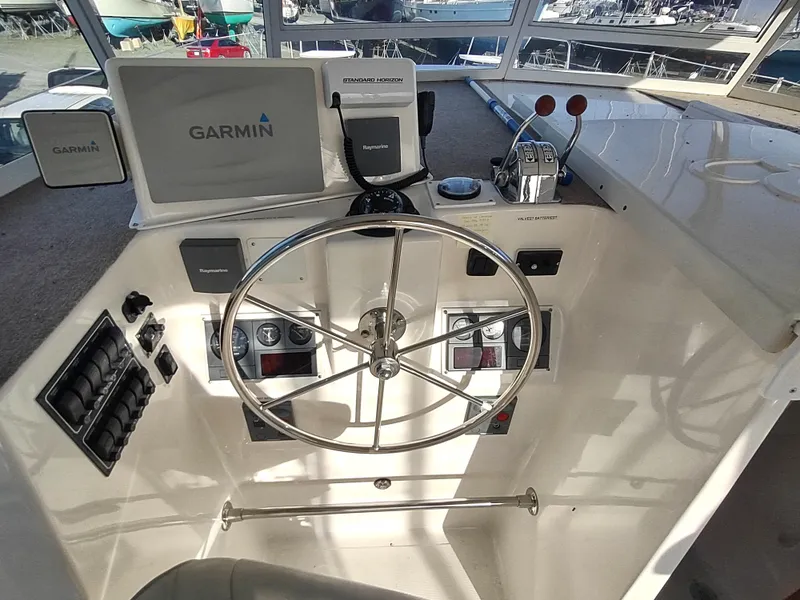 Slide: The Image of Helm of 2002 Endeavour Trawlercat 36 with Garmin navigation system and steering wheel. - 38