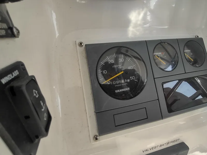 Slide: The Image of Control panel of a 2002 Endeavour Trawlercat 36, featuring Yanmar gauges and switches. - 41