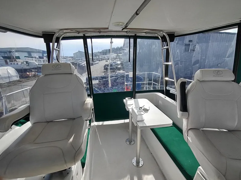 Slide: The Image of 2002 Endeavour Trawlercat 36 interior with seating and table, showcasing spacious cabin design. - 42