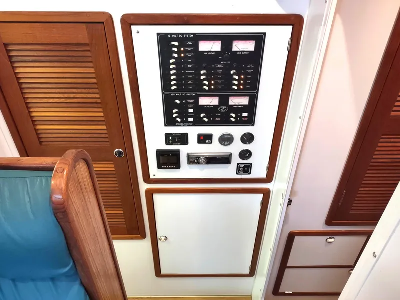 Slide: The Image of Control panel inside 2002 Endeavour Trawlercat 36, featuring gauges and switches. - 48