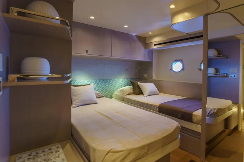 Slide: The Image of Luxurious twin cabin interior on 2026 Absolute 70' Fly yacht, featuring modern design and ambient lighting. - 19