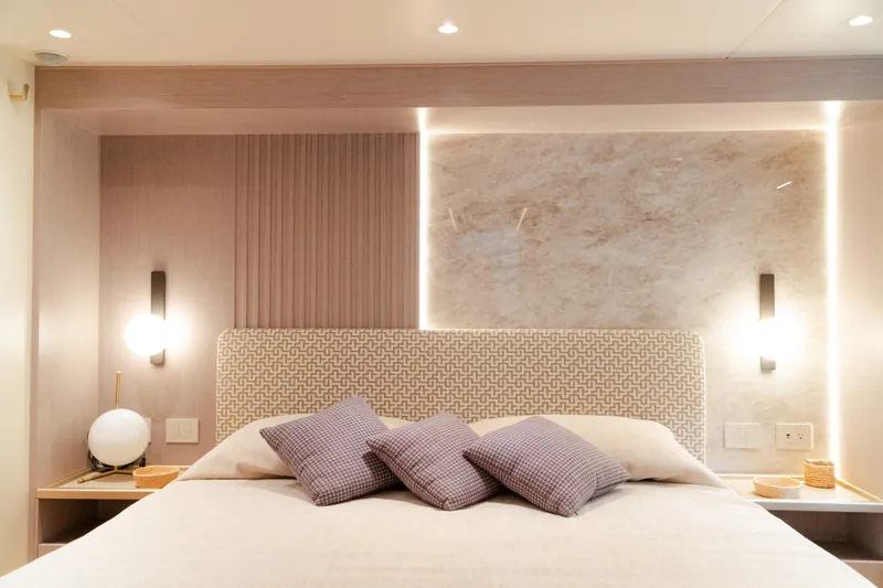 Slide: The Image of Luxurious bedroom interior on 2026 Absolute 70' Fly yacht with modern lighting and elegant decor. - 18