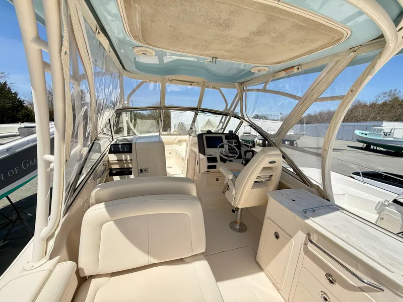 Slide: The Image of 2017 Grady-White Freedom 275 boat interior with helm and seating area. - 10