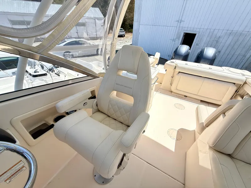 Slide: The Image of 2017 Grady-White Freedom 275 boat interior with white captain's chair and helm. - 12