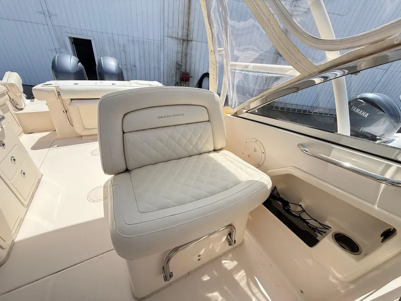 Slide: The Image of 2017 Grady-White Freedom 275 boat interior with cushioned seating and Yamaha engines. - 14