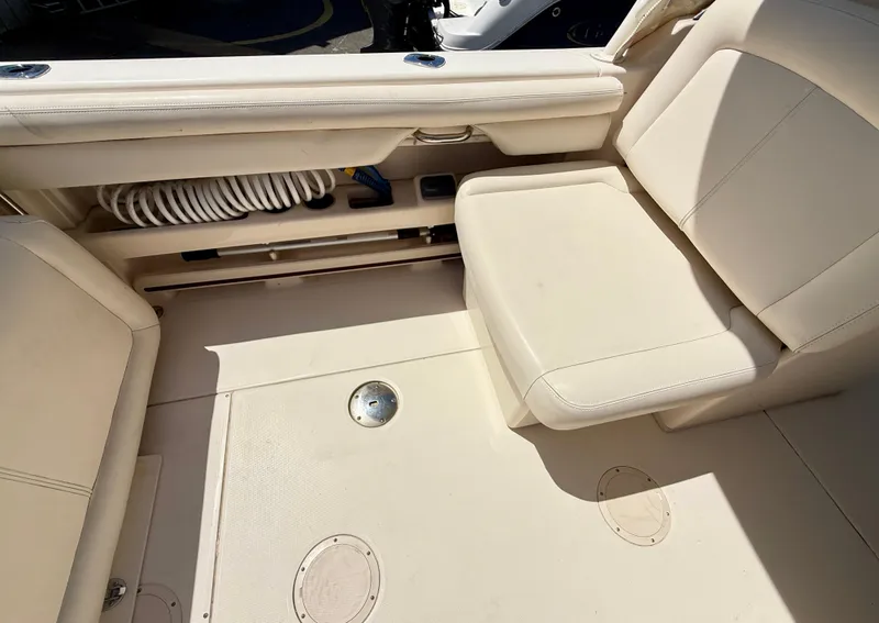 Slide: The Image of 2017 Grady-White Freedom 275 boat interior with beige seating and storage compartment. - 16