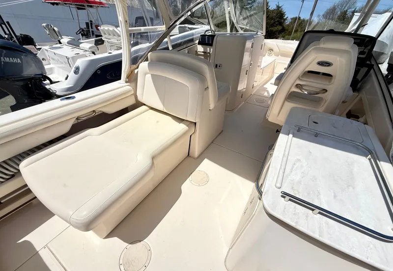 Slide: The Image of 2017 Grady-White Freedom 275 boat interior with seating and console. - 17