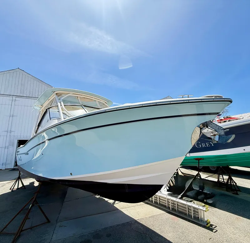Slide: The Image of 2017 Grady-White Freedom 275 boat displayed outdoors under clear blue sky. - 4