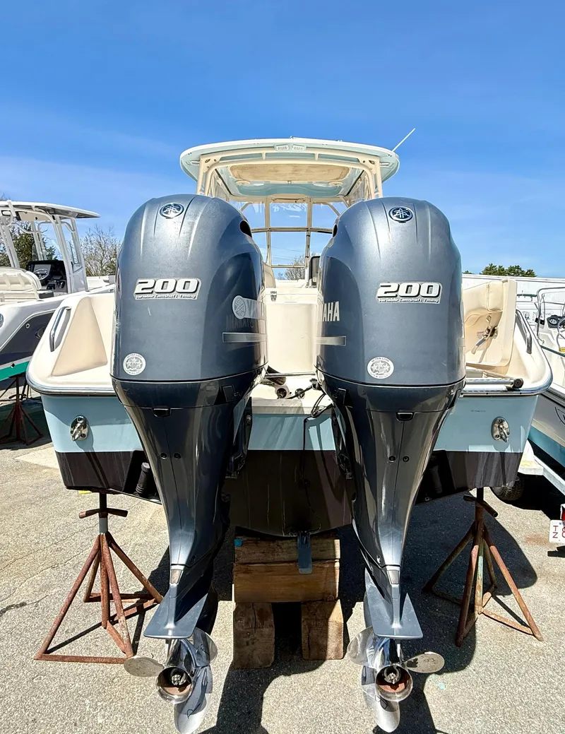 Slide: The Image of 2017 Grady-White Freedom 275 with twin Yamaha 200 engines, docked outdoors. - 5