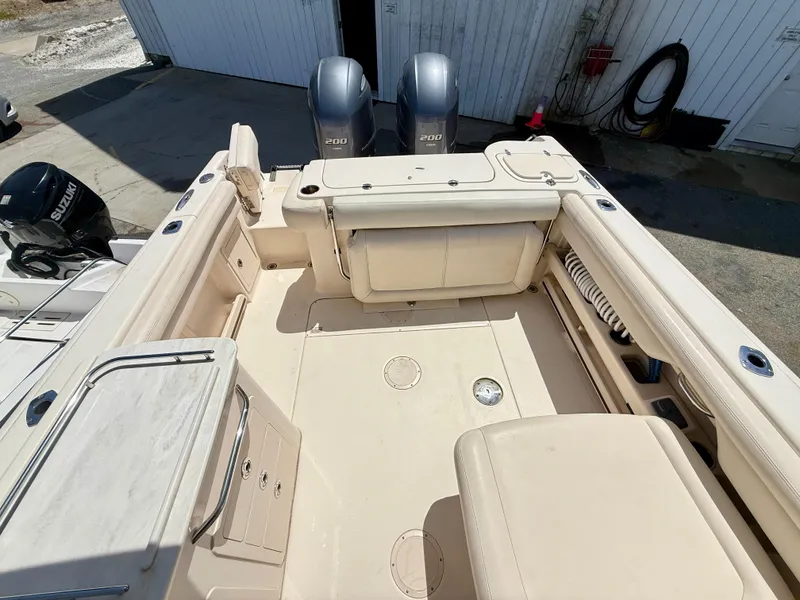 Slide: The Image of 2017 Grady-White Freedom 275 boat interior with twin engines and spacious deck. - 9