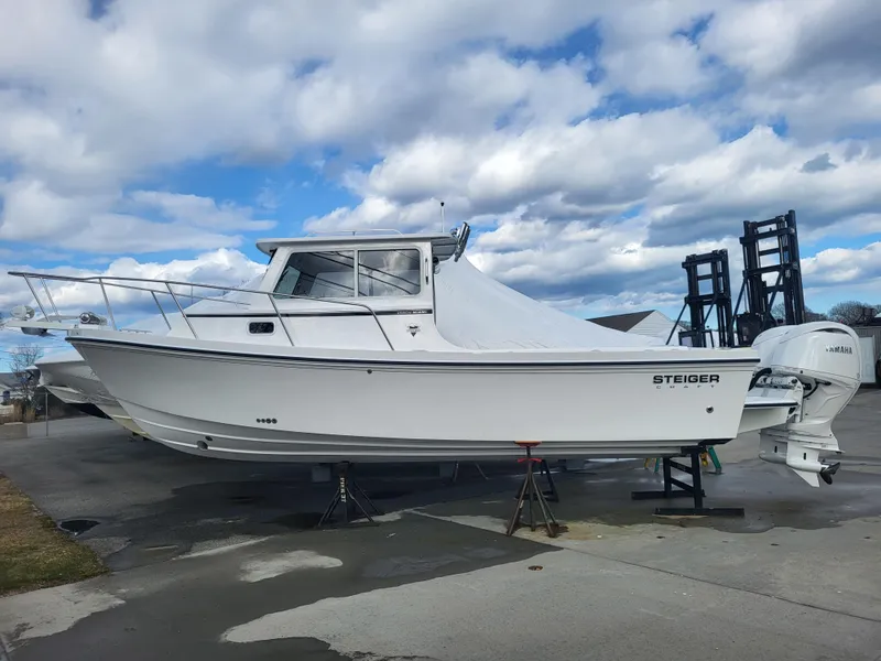 Slide: The Image of 2025 Steiger Craft 255 DV MIAMI boat on display under cloudy sky. - 1