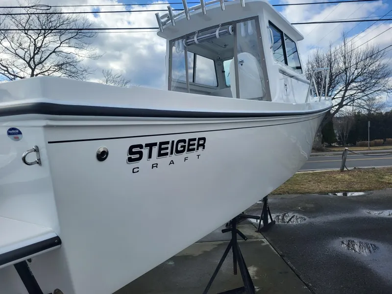 Slide: The Image of 2025 Steiger Craft 255 DV MIAMI boat displayed outdoors on a stand. - 11