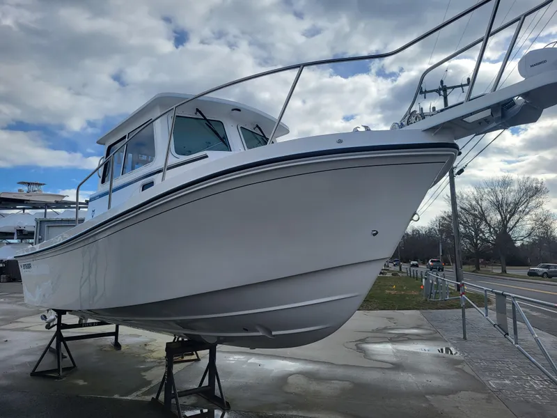 Slide: The Image of 2025 Steiger Craft 255 DV MIAMI boat on display, elevated on stands. - 14