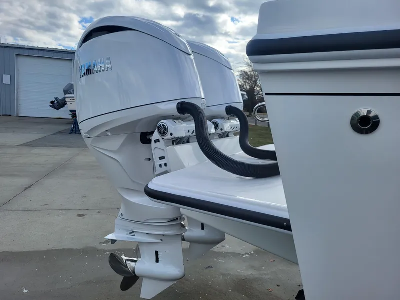 Slide: The Image of 2025 Steiger Craft 255 DV MIAMI with dual outboard motors, docked outdoors. - 17