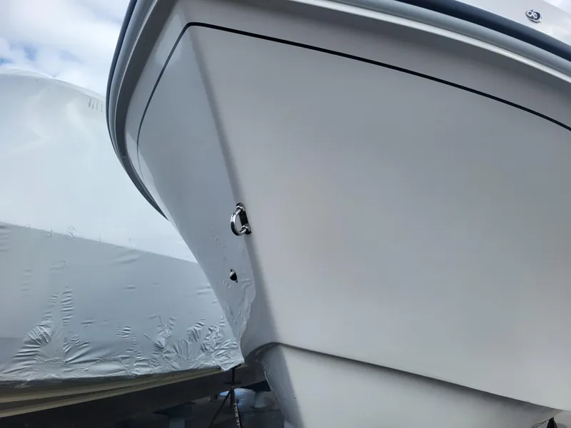 Slide: The Image of 2025 Steiger Craft 255 DV MIAMI boat bow, sleek design, white hull, outdoor display. - 18