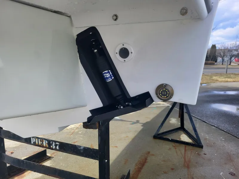 Slide: The Image of 2025 Steiger Craft 255 DV MIAMI boat hull detail with trim tab and mounting bracket. - 19