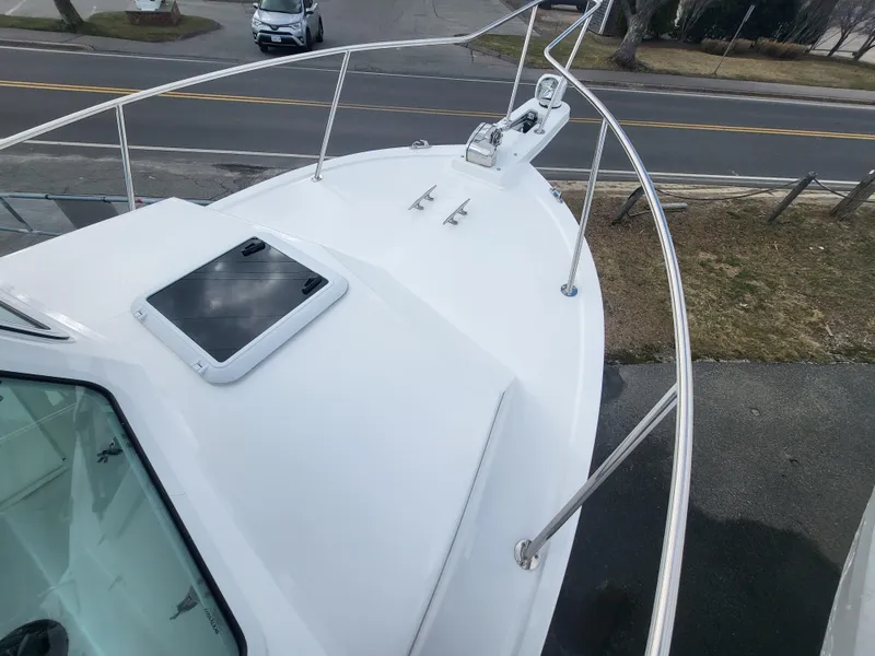 Slide: The Image of 2025 Steiger Craft 255 DV MIAMI boat deck with railing and hatch, viewed from above. - 26