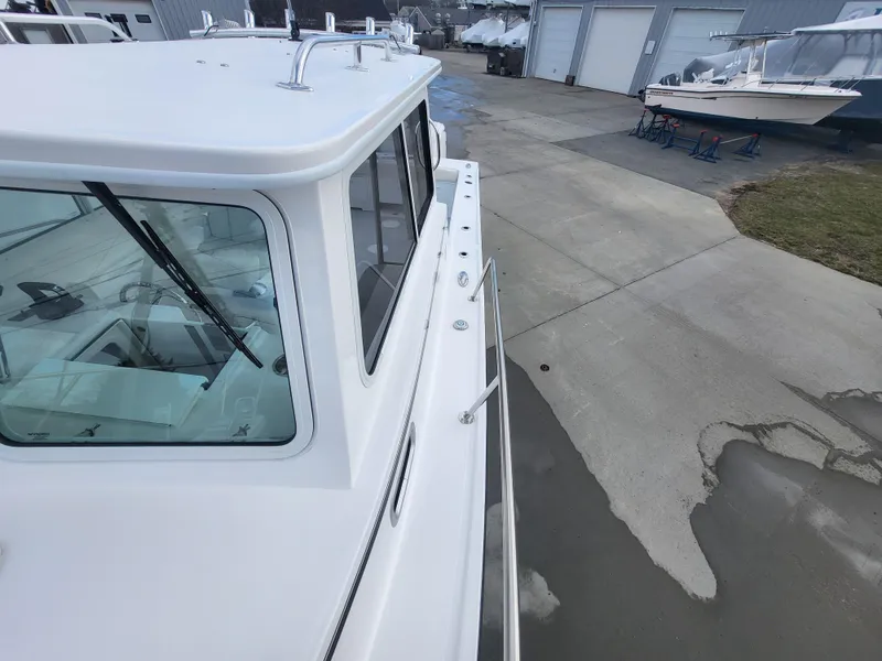 Slide: The Image of 2025 Steiger Craft 255 DV MIAMI boat docked, showcasing cabin and deck details. - 29