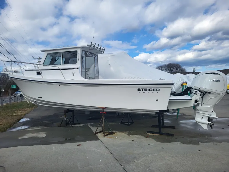 Slide: The Image of 2025 Steiger Craft 255 DV MIAMI boat on display under cloudy sky. - 3
