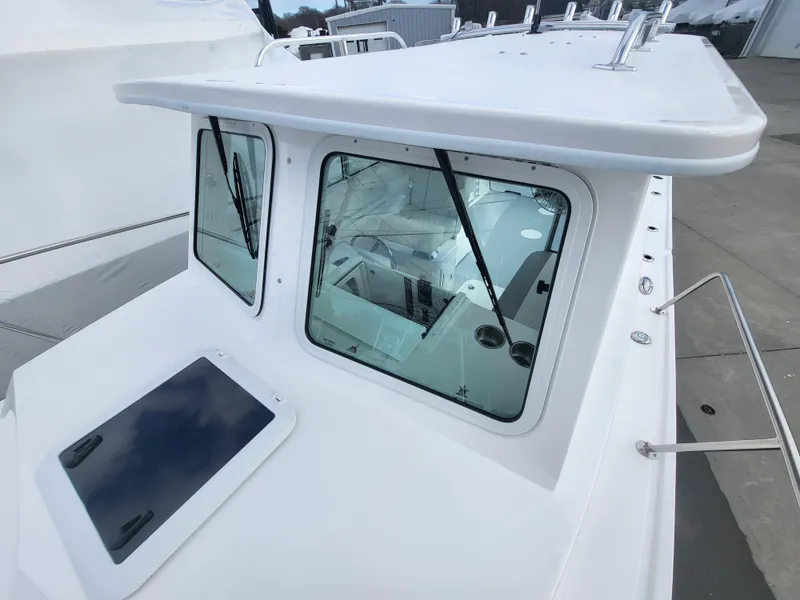 Slide: The Image of 2025 Steiger Craft 255 DV MIAMI boat cabin with large windows and sleek design. - 30