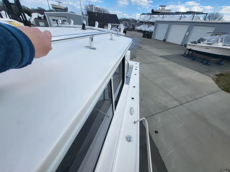 Slide: The Image of 2025 Steiger Craft 255 DV MIAMI boat, viewed from the deck, in a marina setting. - 32