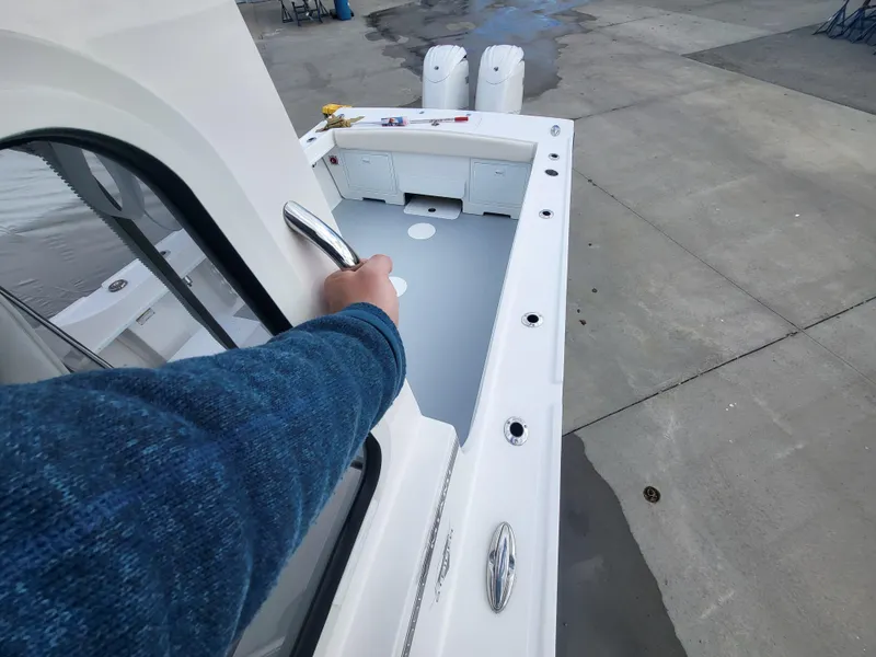 Slide: The Image of 2025 Steiger Craft 255 DV MIAMI boat deck with handrail and storage compartments. - 33