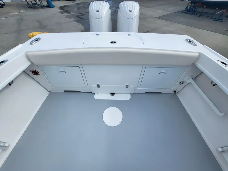 Slide: The Image of 2025 Steiger Craft 255 DV MIAMI boat deck with storage compartments and twin engines. - 43