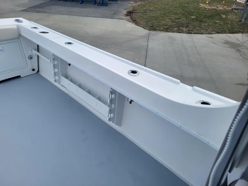 Slide: The Image of 2025 Steiger Craft 255 DV MIAMI boat deck with rod holders and storage compartments. - 47