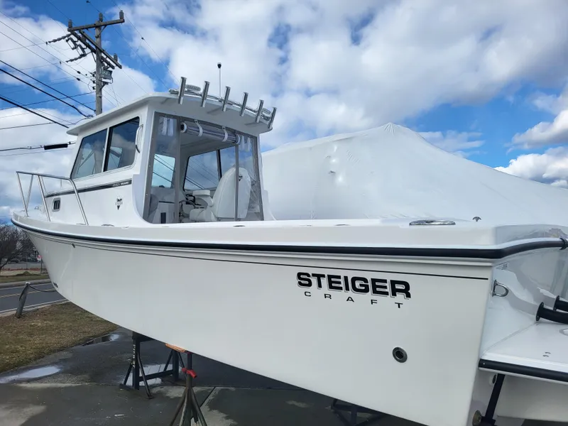 Slide: The Image of 2025 Steiger Craft 255 DV MIAMI boat on display under cloudy sky. - 5