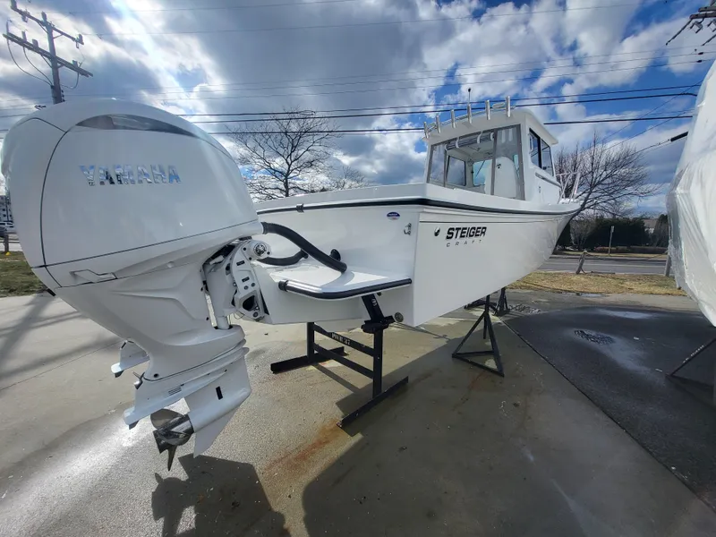 Slide: The Image of 2025 Steiger Craft 255 DV MIAMI boat with Yamaha outboard motor, displayed outdoors. - 9