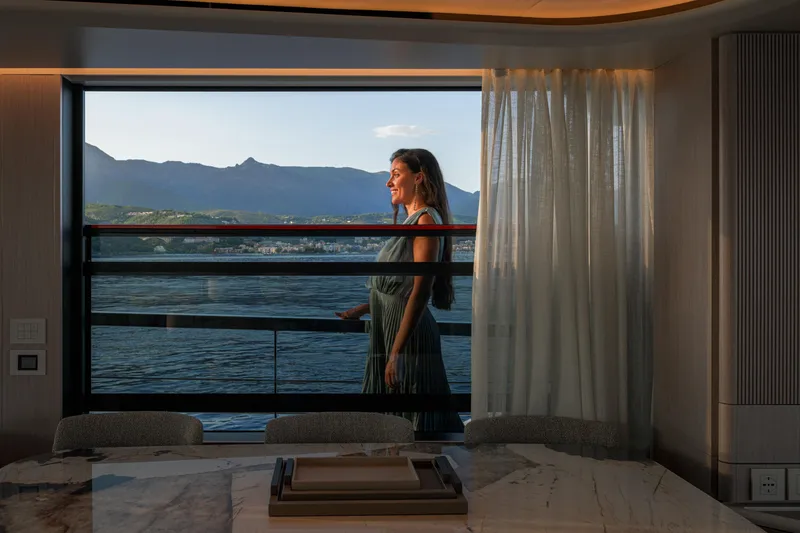 Slide: The Image of Woman enjoying view from Absolute 62' Navetta yacht, 2026 model, with scenic mountain backdrop. - 31