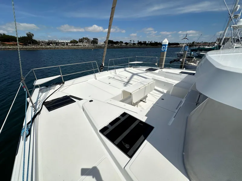Slide: The Image of Bali 4.8 catamaran deck, 2021 model, docked in a marina under a clear sky. - 12