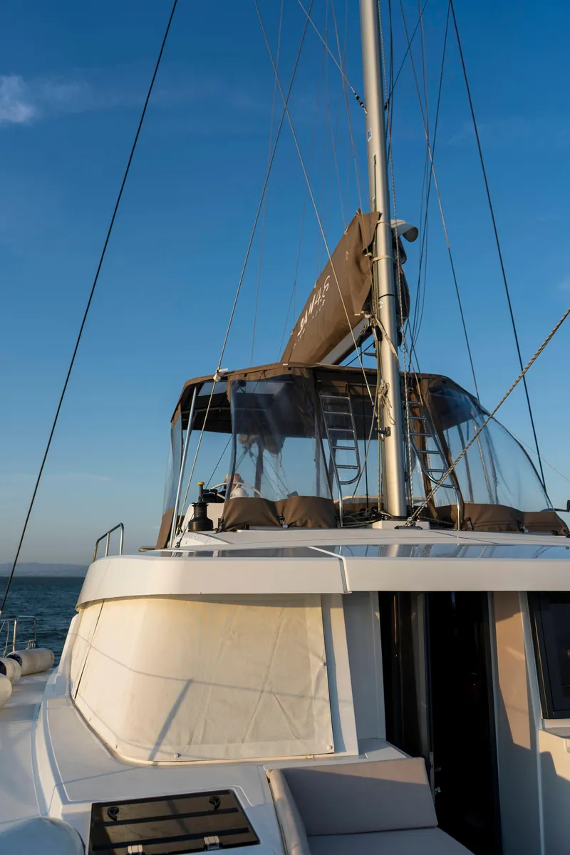 Slide: The Image of 2021 Bali 4.8 catamaran sailing on open sea under clear blue sky. - 13