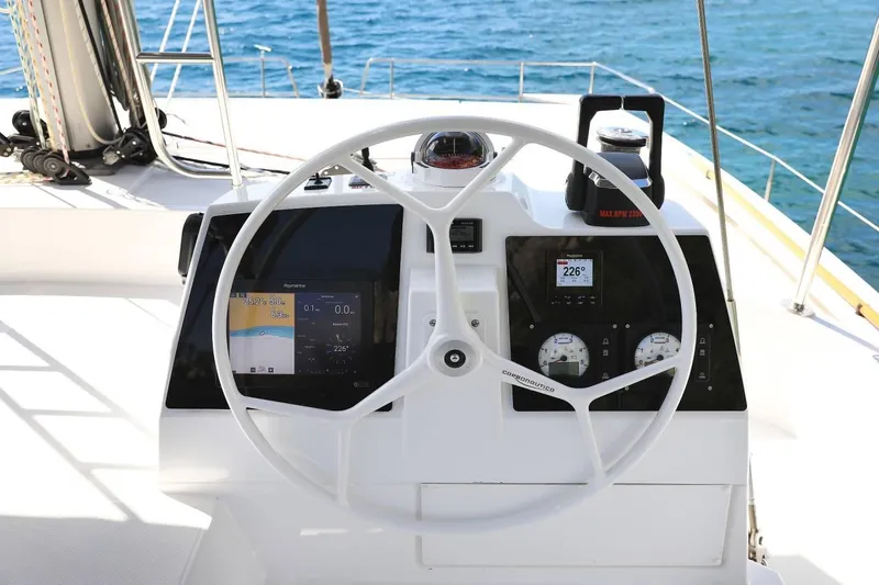 Slide: The Image of Steering wheel and dashboard of a 2021 Bali 4.8 yacht with navigation instruments. - 15