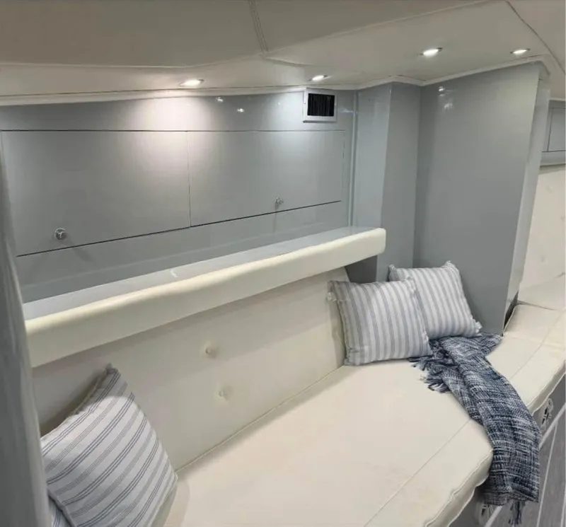 Slide: The Image of Interior of a 1997 Strike 42 boat with cozy seating and striped pillows. - 10