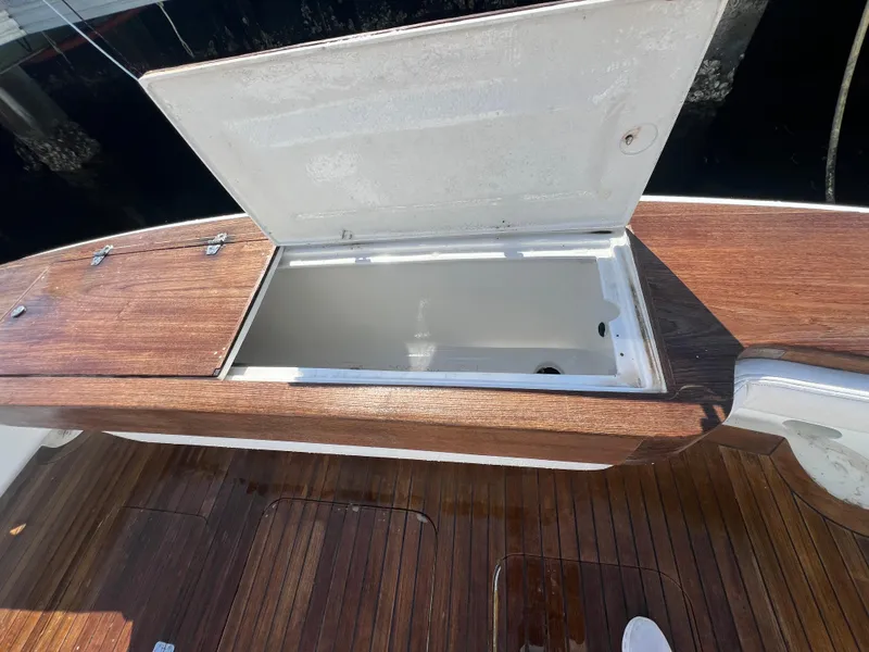 Slide: The Image of Open storage compartment on 1997 Strike 42 boat with wooden deck. - 20
