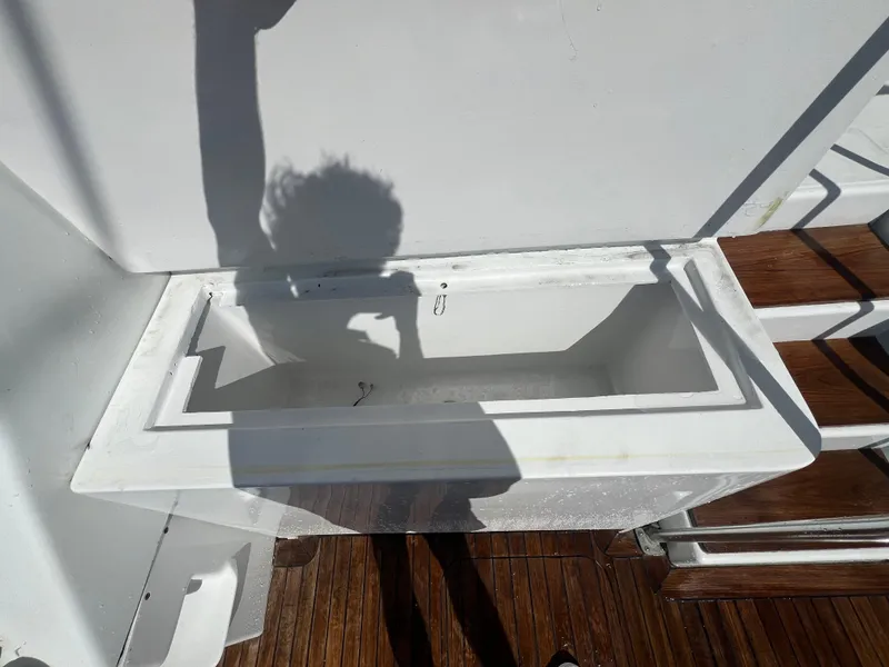 Slide: The Image of Shadow of a person on a boat deck near a white compartment, Strike 42, 1997 model. - 23