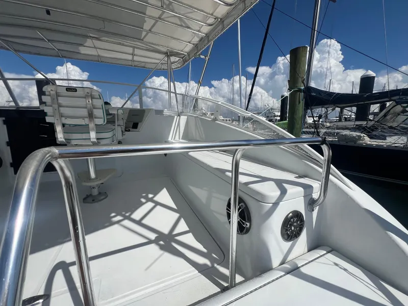 Slide: The Image of 1997 Strike 42 boat deck with seating and railing under a clear sky. - 24