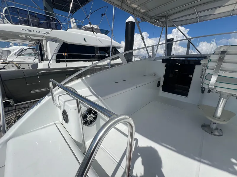 Slide: The Image of 1997 Strike 42 boat deck with seating, railing, and clear sky background. - 26