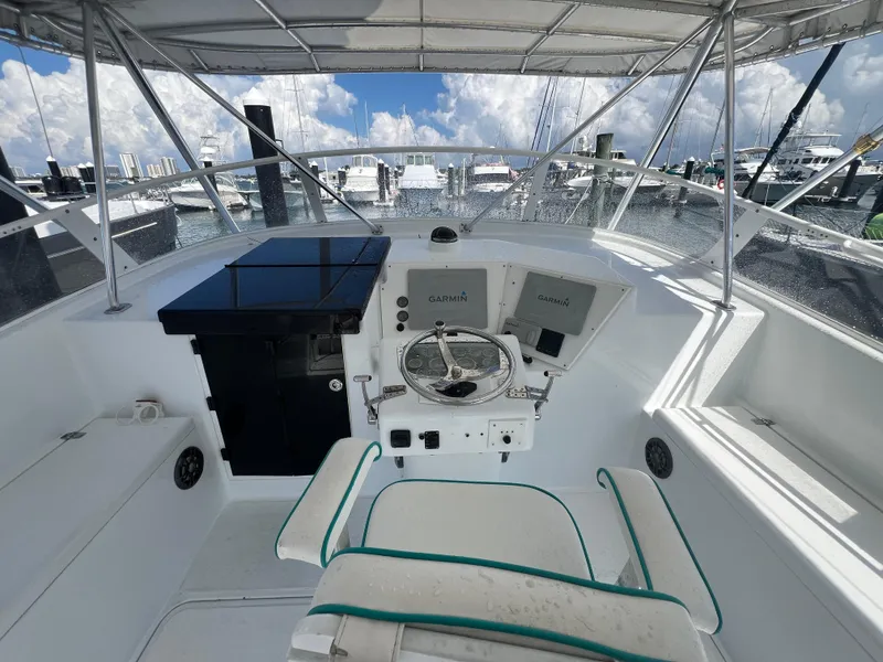 Slide: The Image of Helm of 1997 Strike 42 boat with steering wheel and navigation equipment. - 28