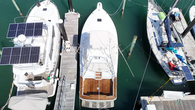 Slide: The Image of Aerial view of a 1997 Strike 42 boat docked between two other boats. - 3