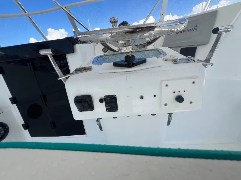 Slide: The Image of Control panel of a 1997 Strike 42 boat with steering wheel and instruments. - 32