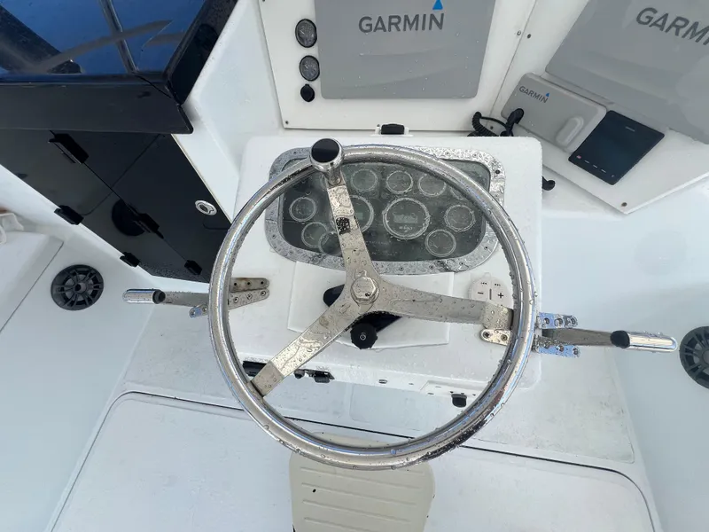 Slide: The Image of Steering wheel of a 1997 Strike 42 boat with Garmin navigation system. - 33