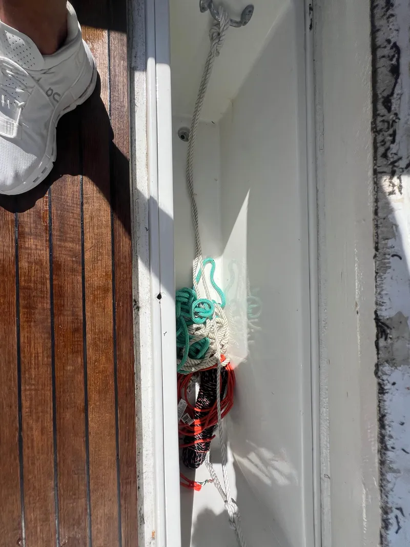 Slide: The Image of Boat deck storage with ropes, wooden flooring, and a sneaker. Strike 42, 1997 model. - 36