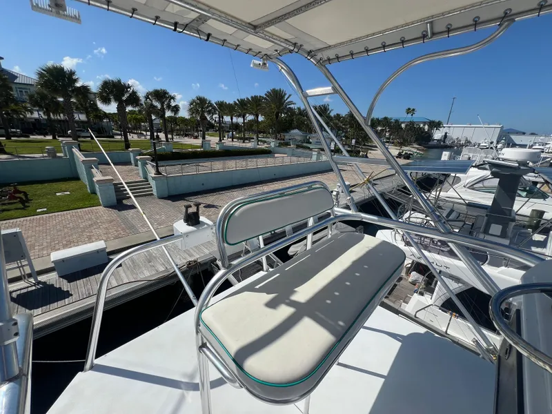 Slide: The Image of 1997 Strike 42 boat deck with seating, docked at marina under clear blue sky. - 38